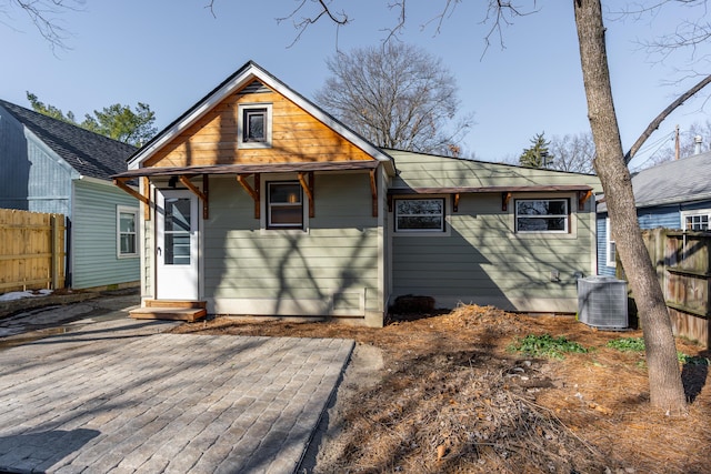 rear view of property featuring a patio area and central air condition unit