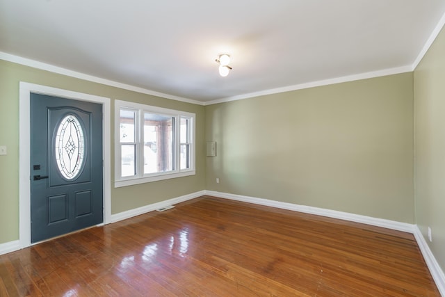 foyer entrance featuring ornamental molding and hardwood / wood-style floors