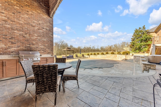 view of patio featuring a gazebo, a grill, and exterior kitchen