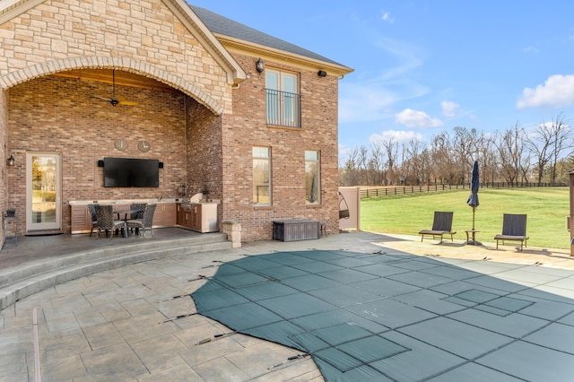 view of swimming pool with a patio, area for grilling, and a yard