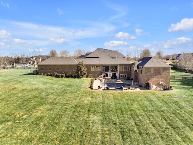 rear view of property with a yard and a patio