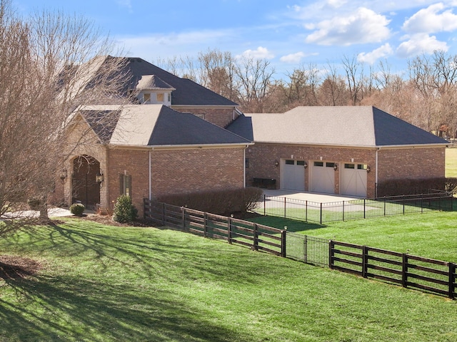 view of side of property featuring a garage and a lawn