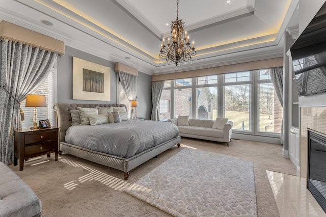 bedroom featuring a raised ceiling, ornamental molding, light carpet, and a chandelier