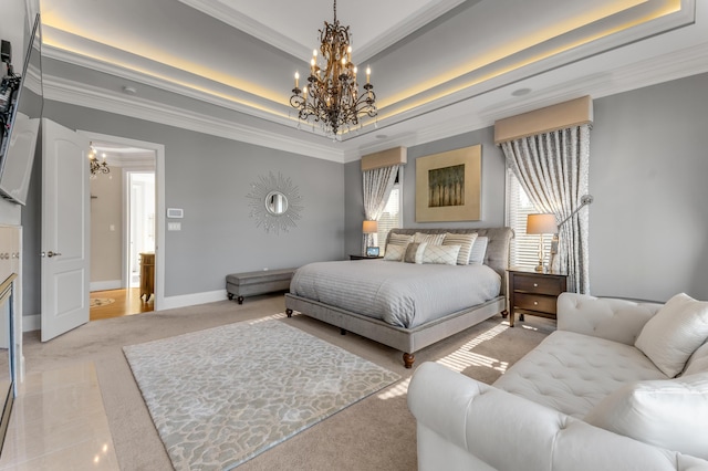 bedroom featuring a raised ceiling, ornamental molding, and a chandelier