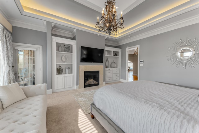 carpeted bedroom featuring crown molding, a raised ceiling, and a tile fireplace