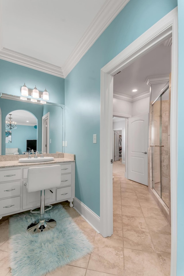 bathroom with crown molding, vanity, and walk in shower