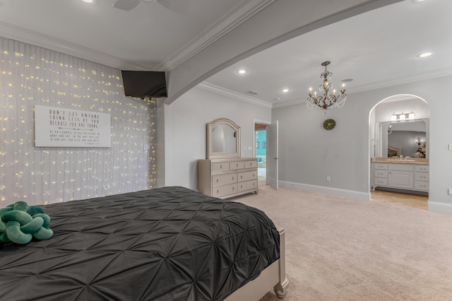 bedroom with crown molding, light carpet, and ensuite bath