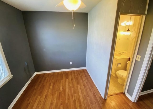 unfurnished room featuring ceiling fan and hardwood / wood-style floors