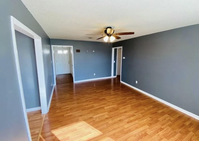 spare room featuring ceiling fan and hardwood / wood-style floors