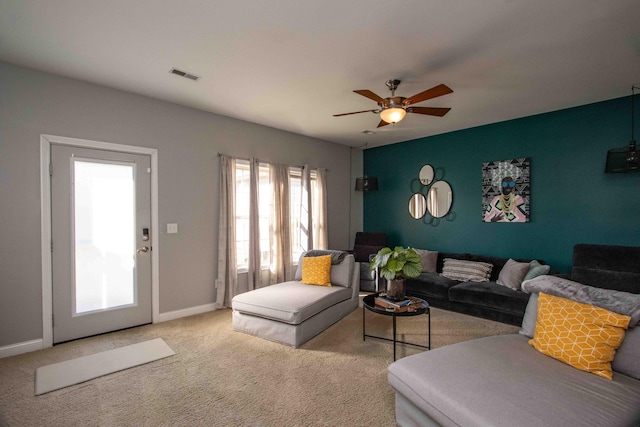 carpeted living room featuring ceiling fan