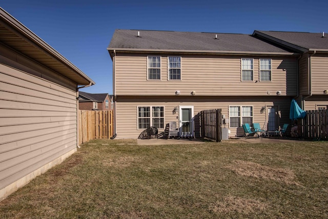 back of property featuring a patio area and a lawn