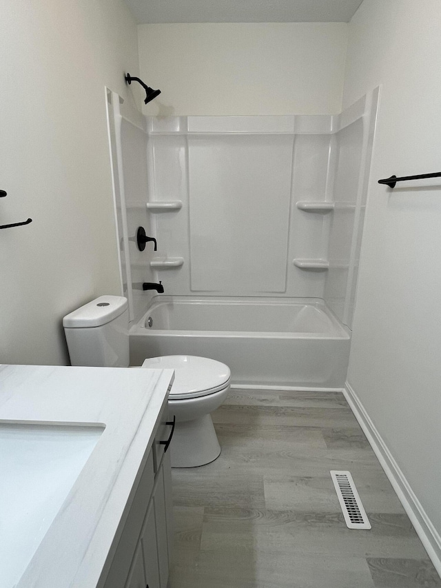 full bathroom with vanity, wood-type flooring, shower / washtub combination, and toilet