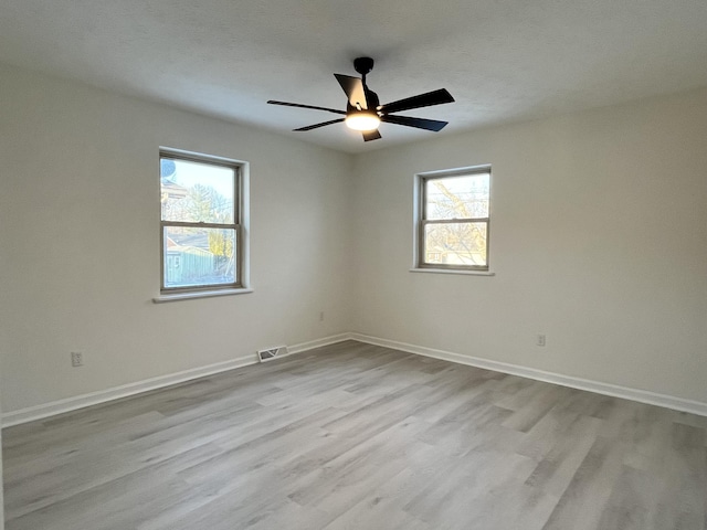 unfurnished room with light hardwood / wood-style floors and ceiling fan