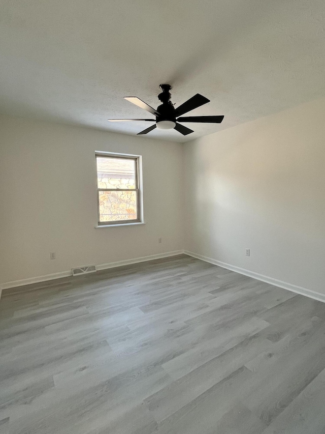 unfurnished room featuring ceiling fan and light hardwood / wood-style floors