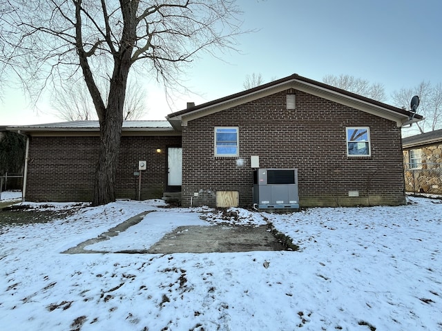 view of snow covered rear of property