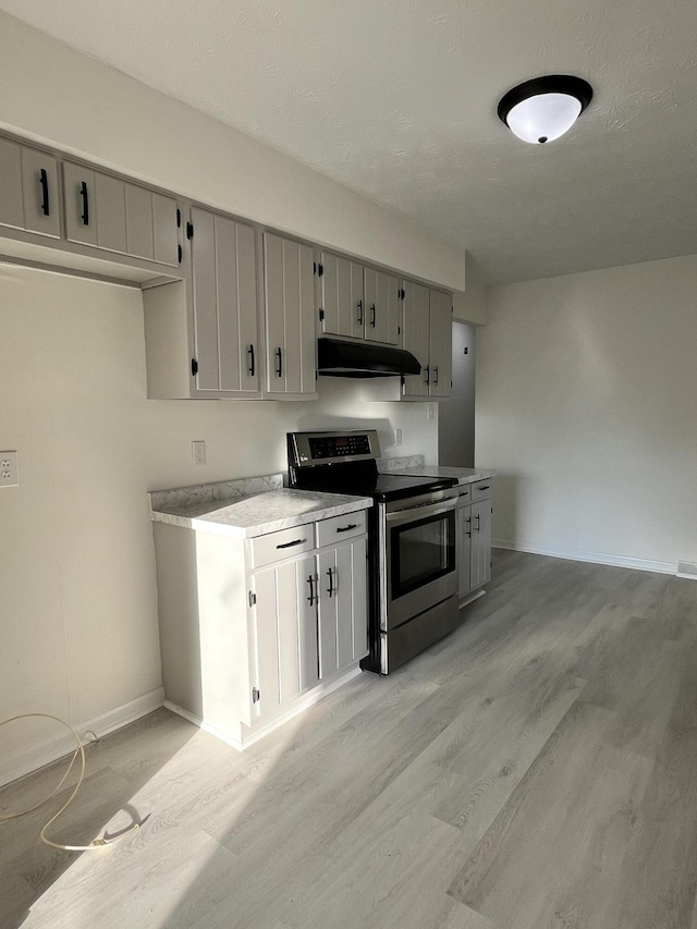 kitchen featuring gray cabinets, stainless steel range with electric cooktop, and light hardwood / wood-style floors