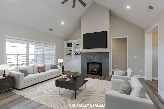 100 Zane Ln, Nicholasville, KY 40356 - living room with visible vents, wood finished floors, a fireplace, high vaulted ceiling, and a ceiling fan