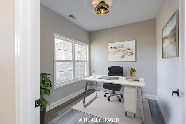 office featuring baseboards, visible vents, and wood finished floors