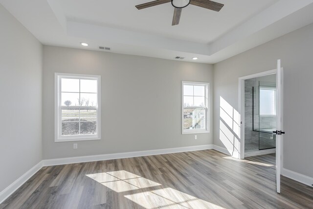 interior space with wood finished floors, visible vents, and baseboards