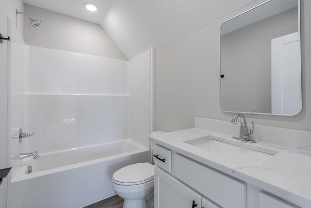 bathroom with shower / tub combination, vaulted ceiling, vanity, and toilet