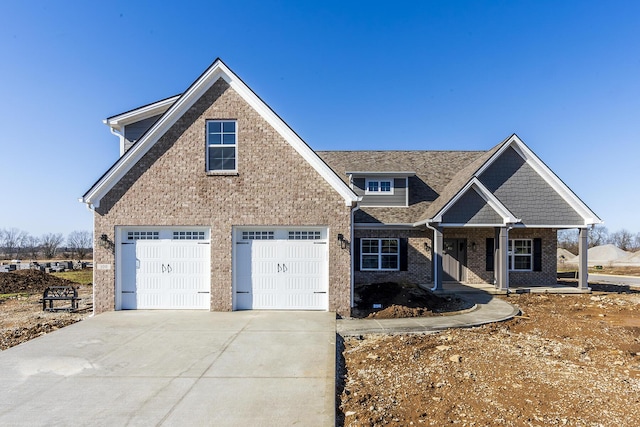 view of front of house with a garage, concrete driveway, and brick siding