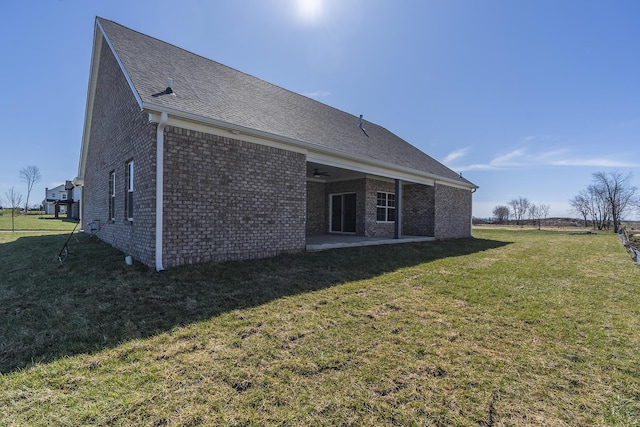 100 Zane Ln, Nicholasville, KY 40356 - back of house with a shingled roof, brick siding, a patio area, a ceiling fan, and a yard