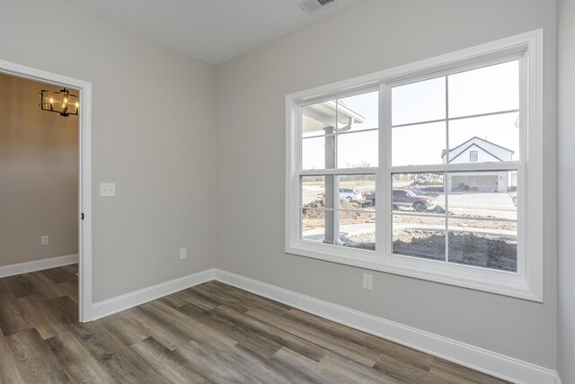 living area featuring dark wood-style floors, visible vents, and high vaulted ceiling