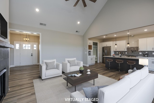 100 Zane Ln, Nicholasville, KY 40356 - living area featuring high vaulted ceiling, visible vents, dark wood finished floors, and ceiling fan with notable chandelier