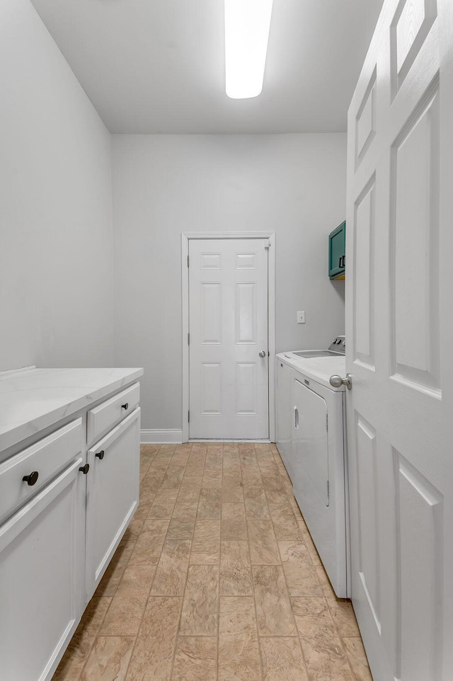 laundry room with cabinets and separate washer and dryer