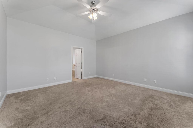 carpeted empty room featuring vaulted ceiling and ceiling fan