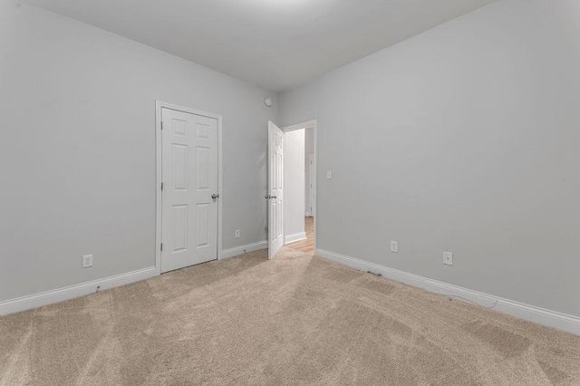 unfurnished room with light carpet