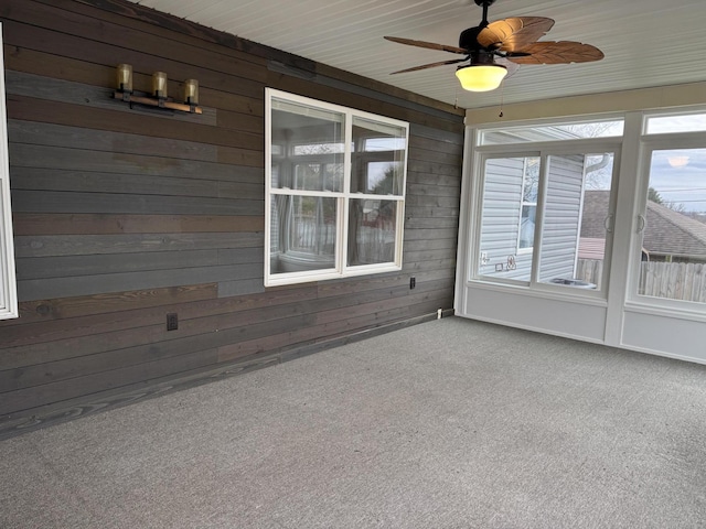 unfurnished sunroom featuring ceiling fan