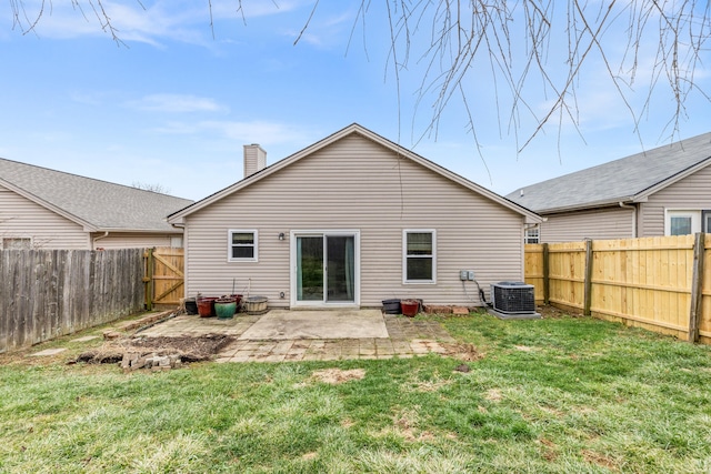 rear view of house with a yard, a patio area, and central air condition unit