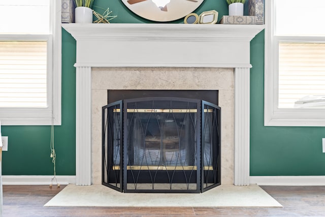 interior details with hardwood / wood-style flooring and a premium fireplace