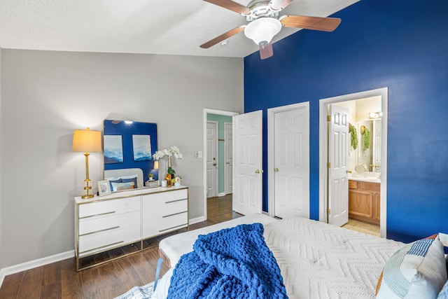 bedroom with vaulted ceiling, ceiling fan, ensuite bathroom, and hardwood / wood-style floors