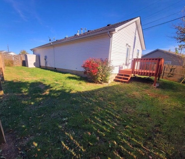 exterior space with a wooden deck and a yard