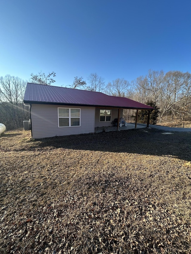 view of front of house featuring a carport and central AC unit