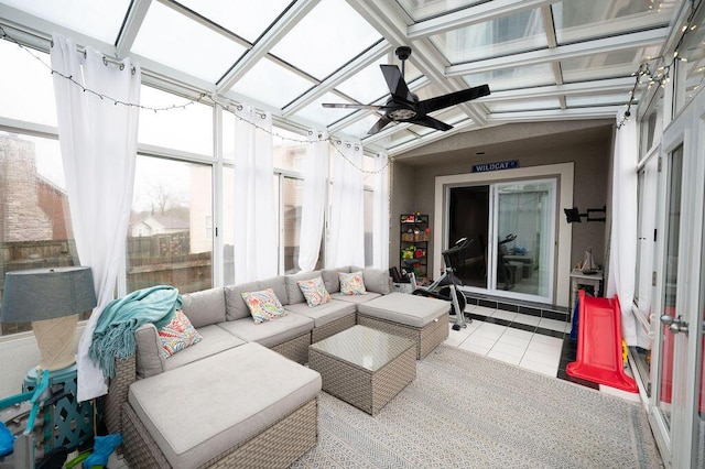 sunroom featuring ceiling fan and vaulted ceiling