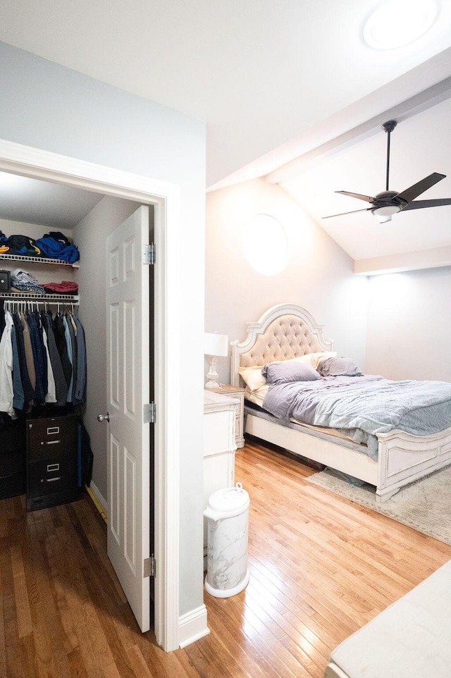 bedroom with vaulted ceiling with beams, hardwood / wood-style flooring, a closet, and ceiling fan