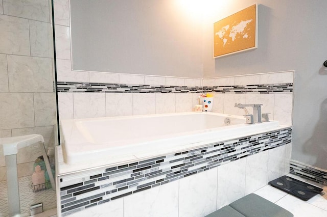 bathroom with a relaxing tiled tub