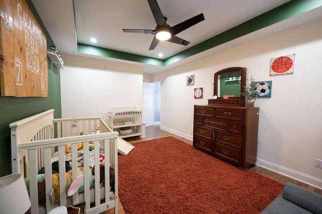 bedroom with hardwood / wood-style flooring and a raised ceiling