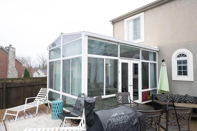 exterior space with a sunroom and french doors