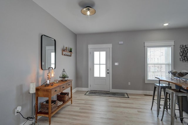 foyer entrance with light wood finished floors, baseboards, and recessed lighting