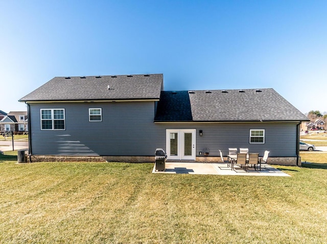 back of house featuring roof with shingles, a lawn, a patio area, and cooling unit