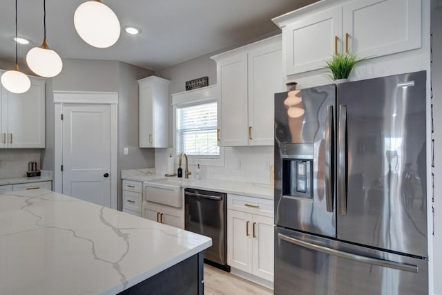 kitchen with stainless steel fridge with ice dispenser, backsplash, white cabinets, a sink, and dishwashing machine