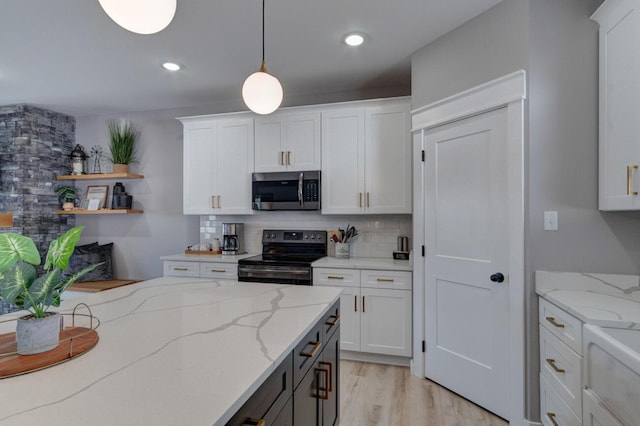 kitchen with appliances with stainless steel finishes, white cabinetry, and tasteful backsplash