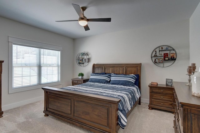 bedroom featuring baseboards, a ceiling fan, and light colored carpet