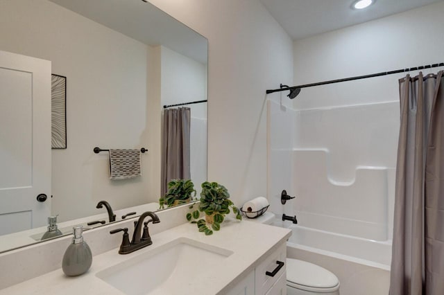 bathroom with shower / bath combo, vanity, and toilet