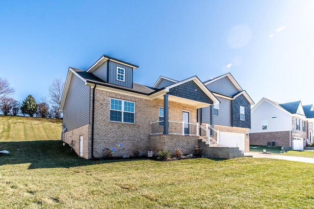 view of front of house with brick siding, a porch, an attached garage, driveway, and a front lawn