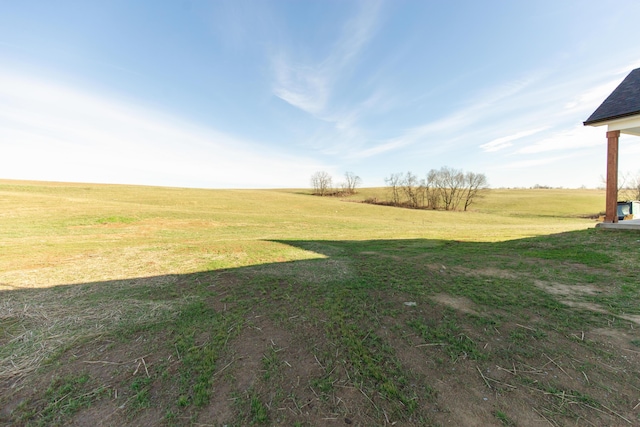 view of yard with a rural view